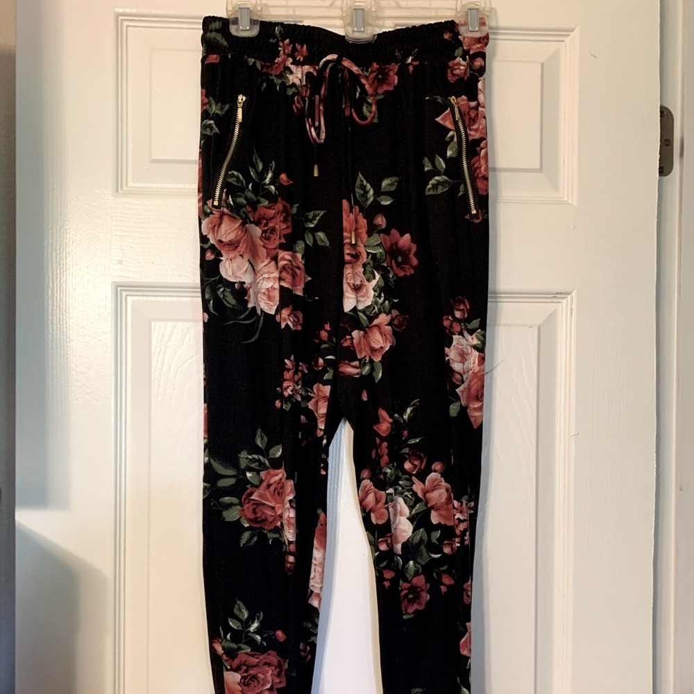 Pre owned black floral jogger pants. Size M